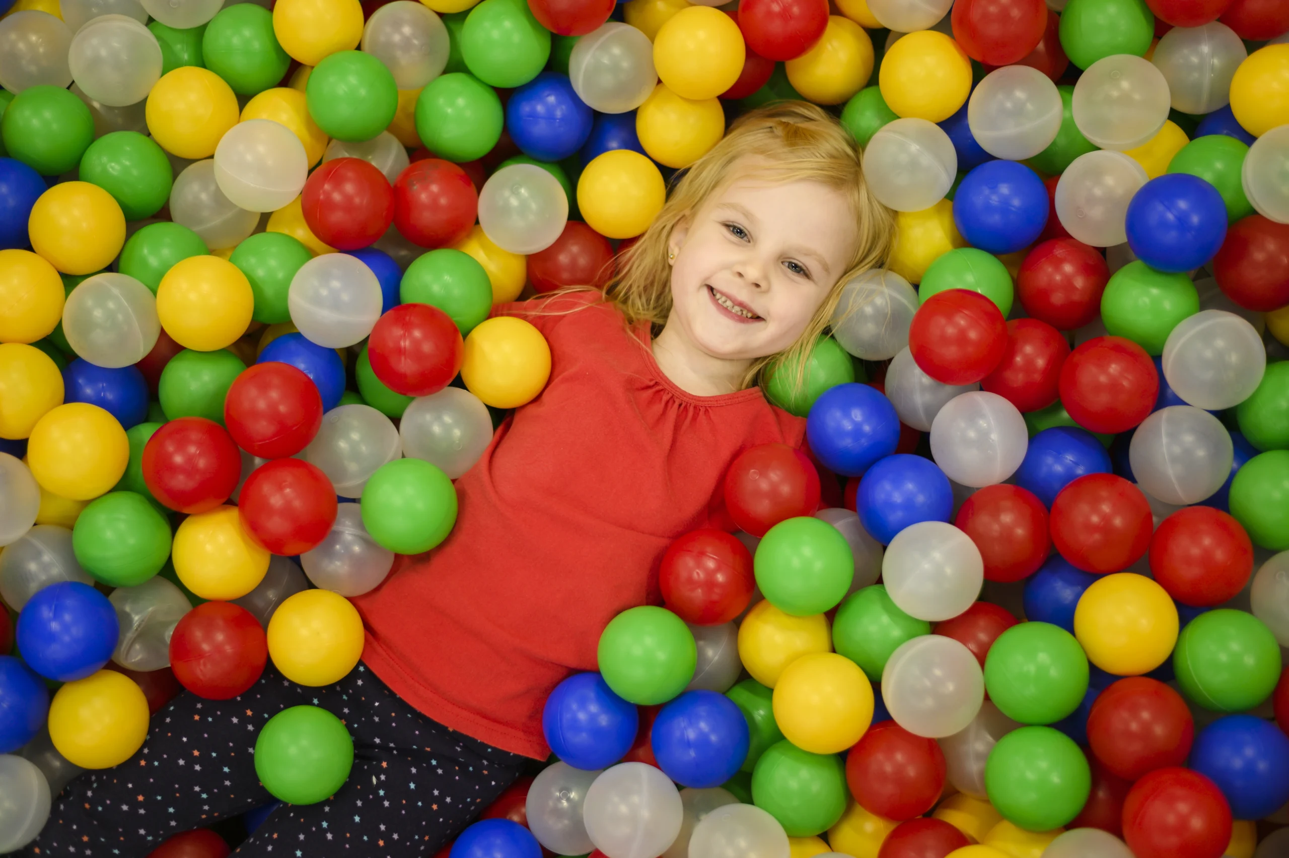 Kid enjoying the ball pit at Gogo Village indoor play area in Dubai, a fun and safe soft play environment for children